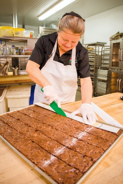 Natalie Detwiler prepping the bakery with freshly made sweets