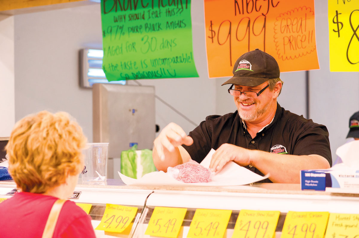 Owner Henry Sr behind the butcher counter.