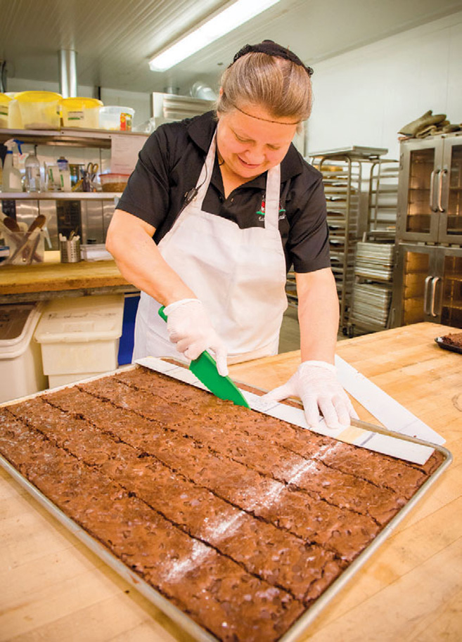 Natalie Detwiler prepping the bakery with freshly made sweets