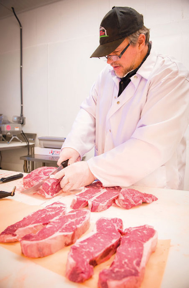 Henry Sr getting steaks ready for the butcher counter